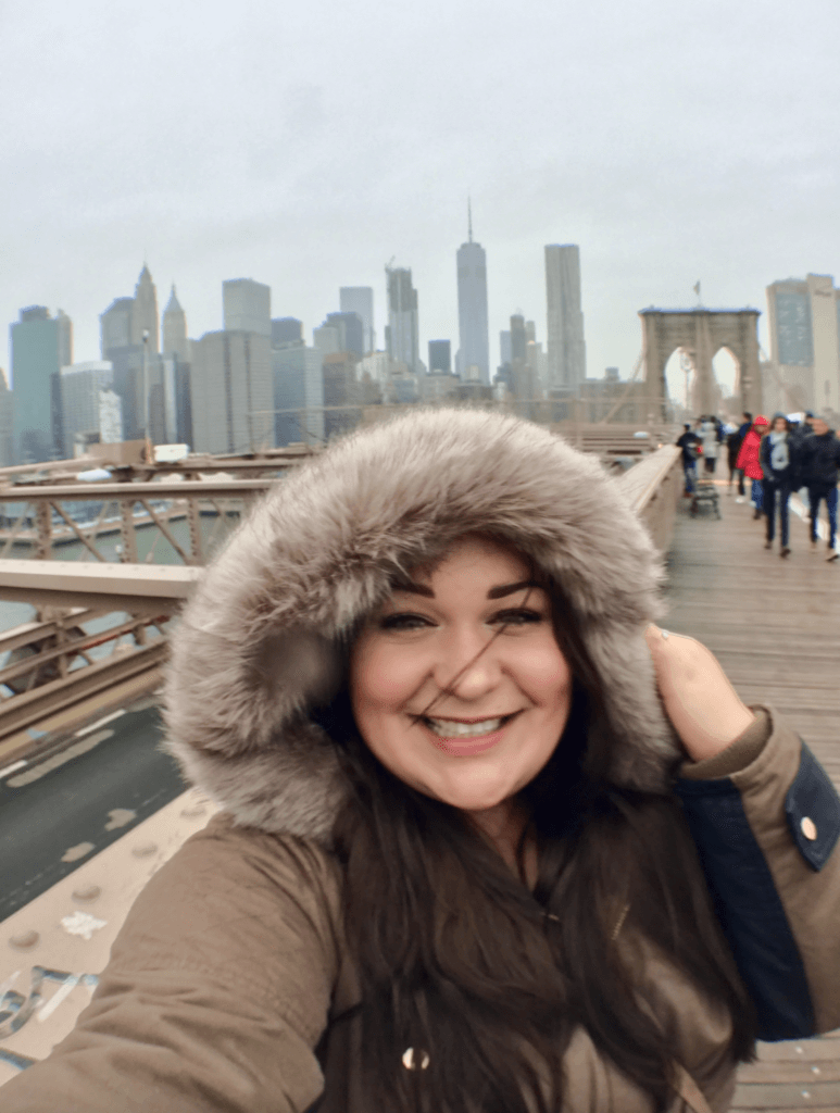 Ellie walking across the Brooklyn Bridge in the rain