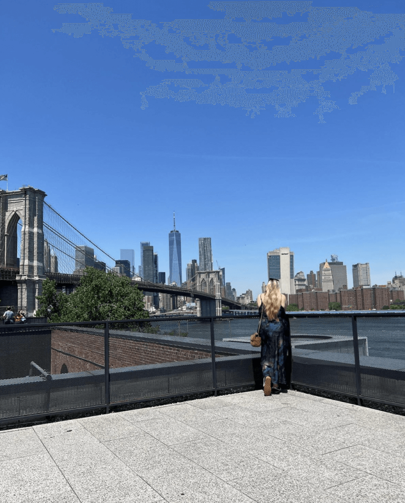 Here I am, overlooking the Brooklyn Bridge from the Time Out Market rooftop. I told you it was a great view!