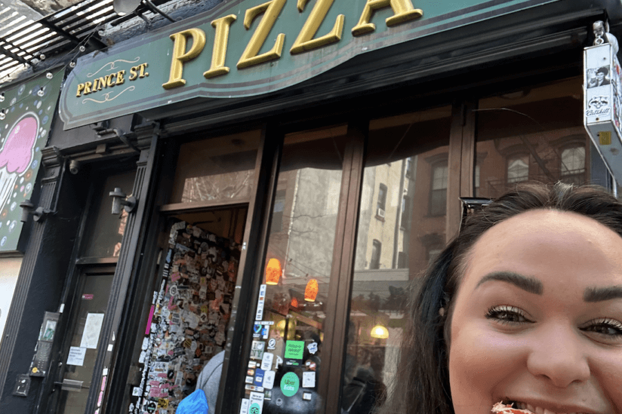 Ellie eating at Prince Street Pizza