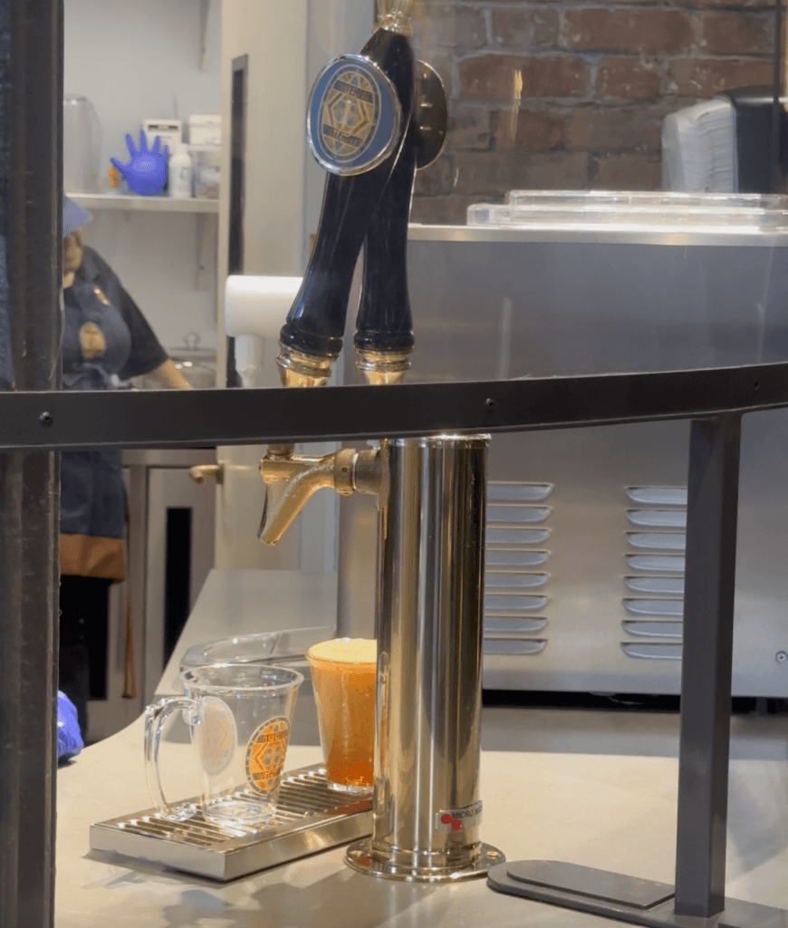 Butterbeer being poured from a draft tap. 