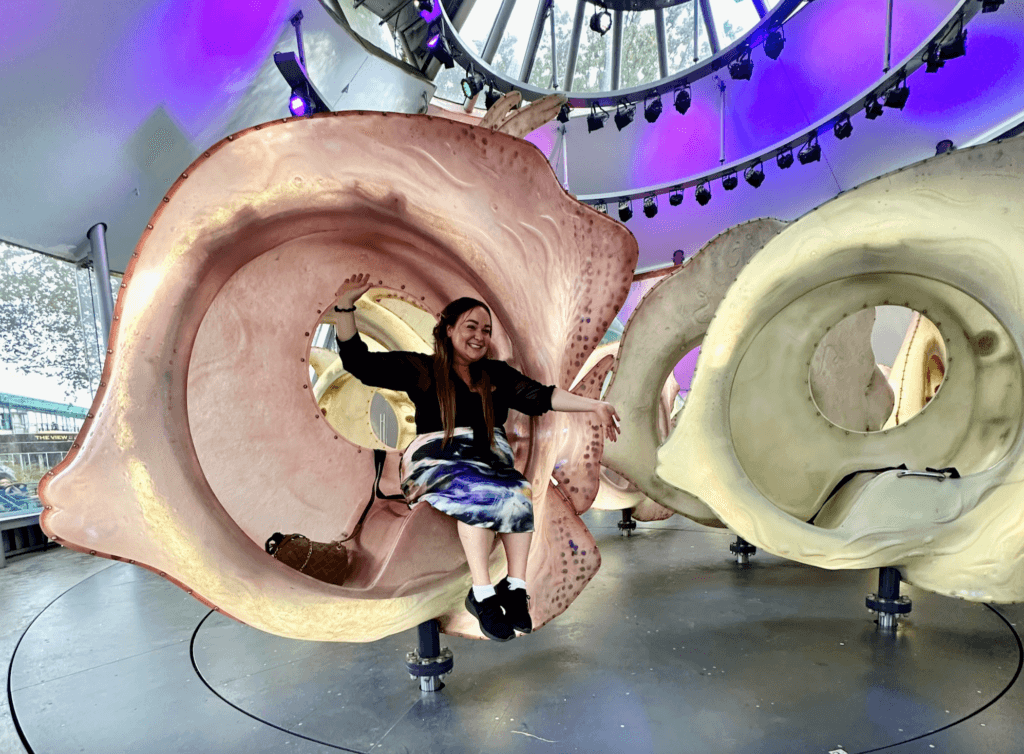 Ellie sitting inside the SeaGlass carousel in NYC