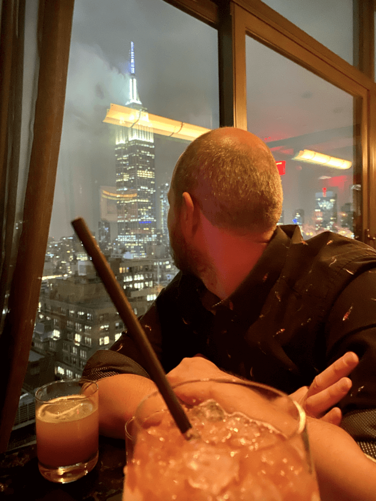 Ellie's husband sat in a bar with rain outside the window
