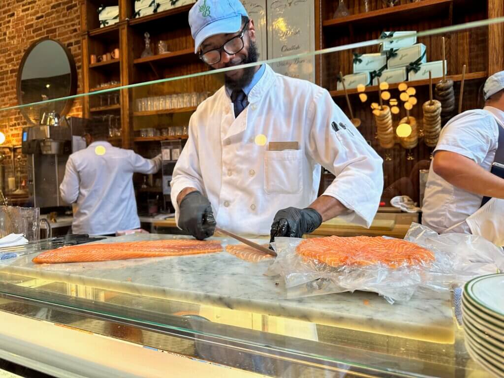 Sadelle's chef cutting smoked salmon