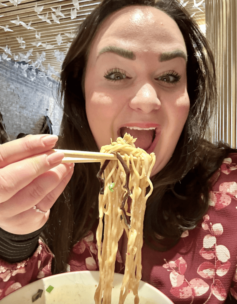 Ellie eating ramen in NYC