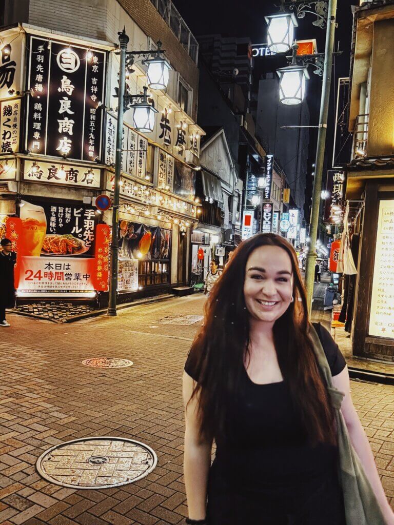 Ellie stood in a busy Tokyo street at night time