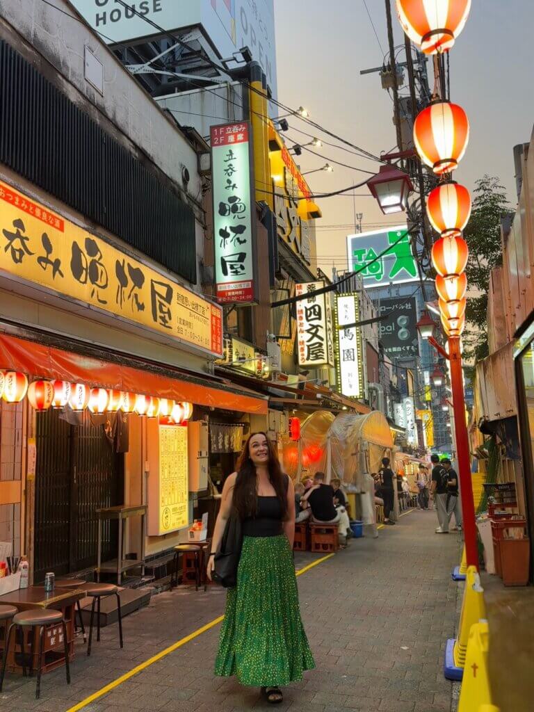 Ellie stood in a small Tokyo alleyway 