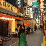 Ellie stood in a small Tokyo alleyway