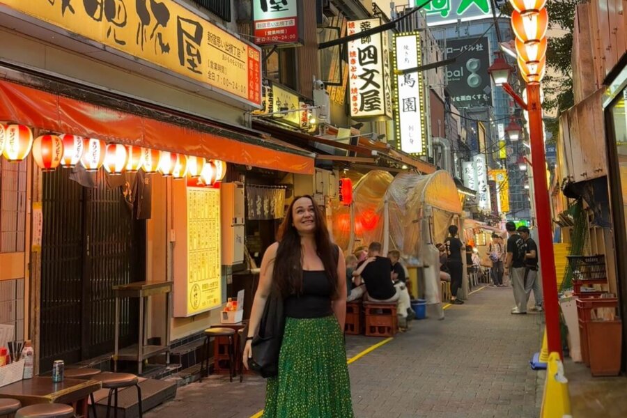 Ellie stood in a small Tokyo alleyway