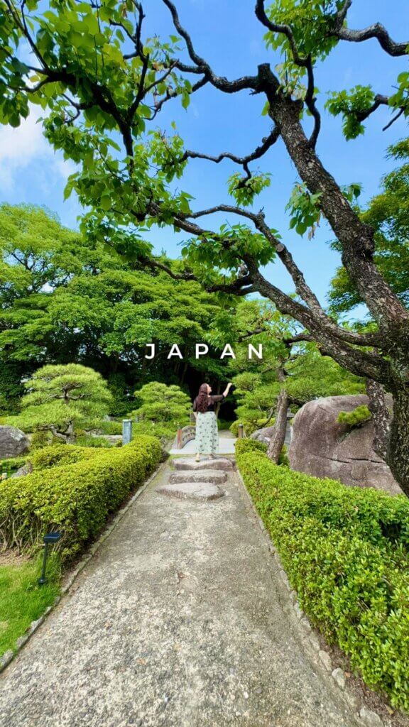 Woman walking through japanese garden