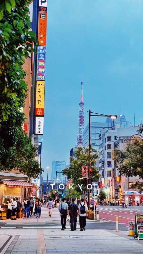Tokyo streets at twilight with friends walking in the distance