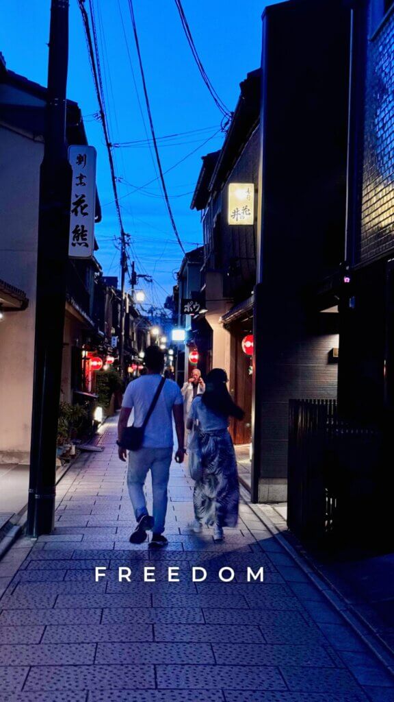 couple strolling the old streets of kyoto at twilight